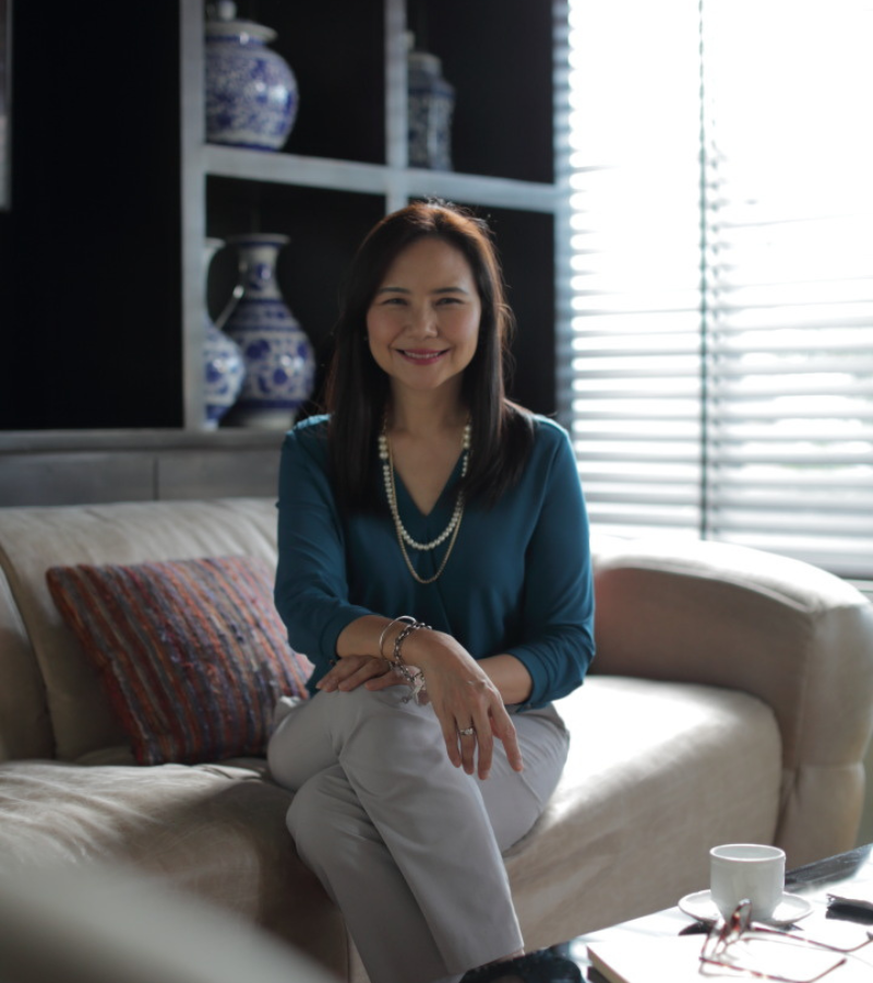 woman seating on couch with a blue blazer