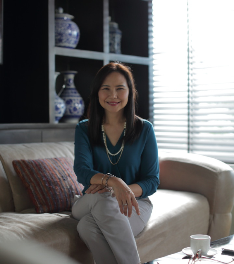 woman with blue dress seating on a chair