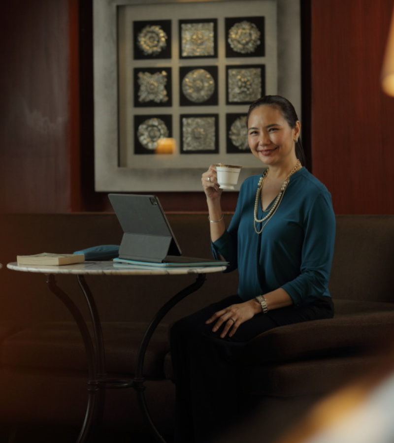 woman seated on a chair with her tea