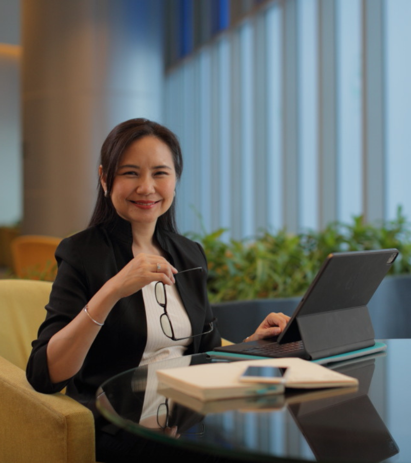 woman seated on chair with her laptop