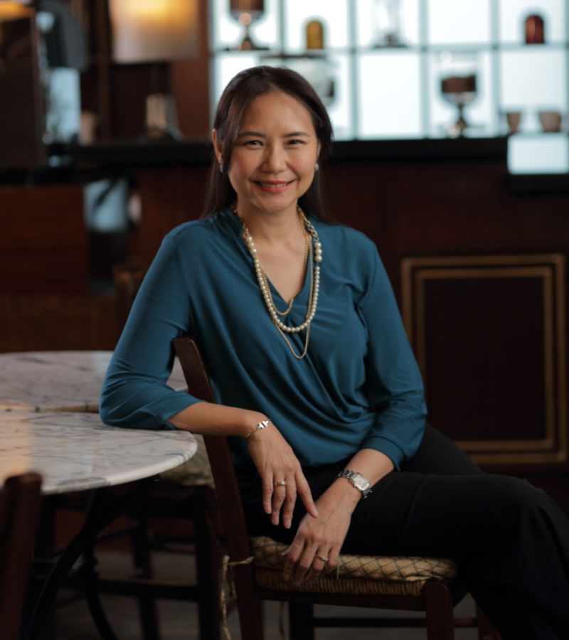 woman seated on a chair with blue blazer