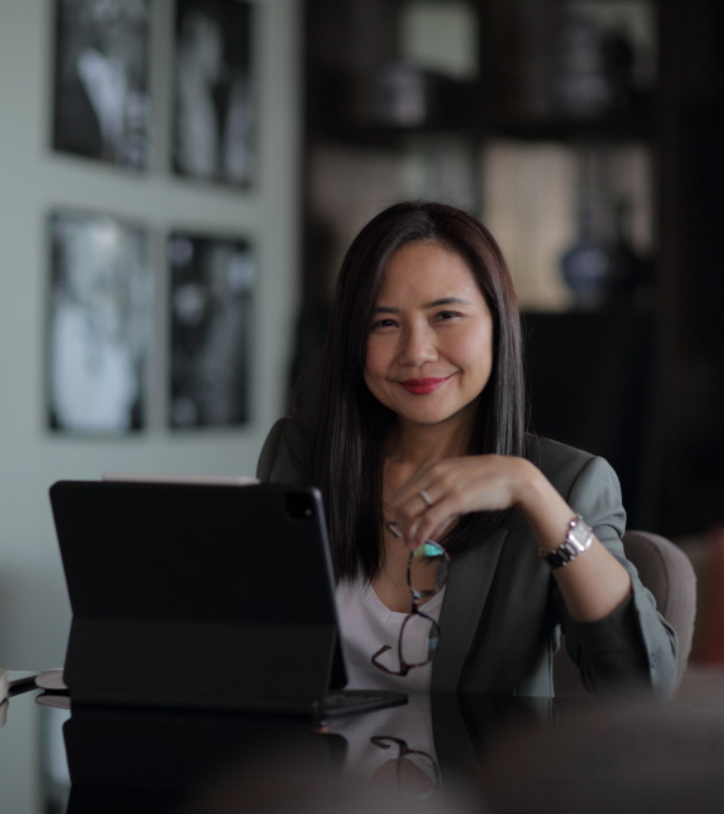 a woman wearing a blazer seating on a table