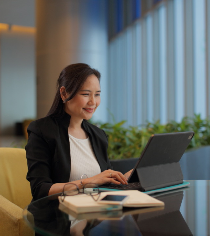 woman seated looking at her laptop