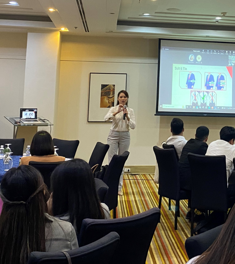 woman conducting a seminar to a group of people